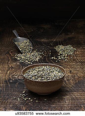 Stock Photography - Still life with bowl of puy lentils and scoop. Fotosearch