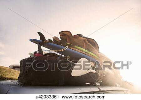 Surfing equipment on roof of car View Large Photo Image Stock Image - Surfing equipment on roof of car. Fotosearch