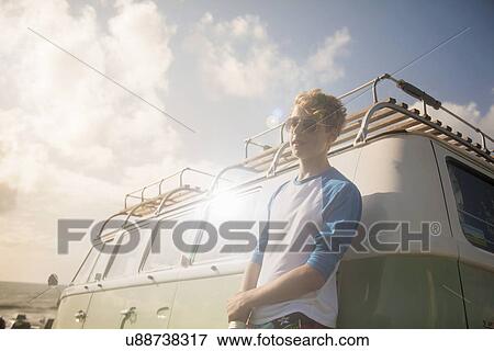 Teenage boy leaning against vehicle View Large Photo Image Stock Photo - Teenage boy leaning against vehicle. Fotosearch