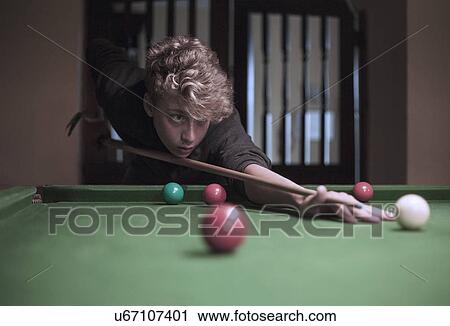 Teenage boy playing snooker View Large Photo Image Stock Image - Teenage boy playing snooker. Fotosearch