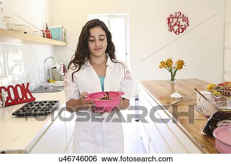 Teenage girl in white apron baking cake in kitchen View Large Photo Image Stock Photograph - Teenage girl in white apron baking cake in kitchen. Fotosearch
