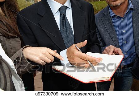 Stock Photo - Three people with blank notebook. Fotosearch