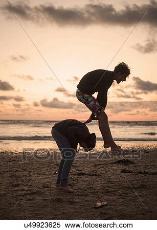 Two boys playing leapfrog on beach View Large Photo Image Stock Photography - Two boys playing leapfrog on beach. Fotosearch
