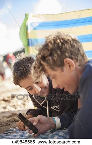 Two boys using smartphone View Large Photo Image Stock Photography - Two boys using smartphone. Fotosearch