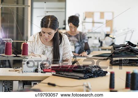 Two seamstresses using sewing machines in workshop View Large Photo Image Stock Photo - Two seamstresses using sewing machines in workshop. Fotosearch