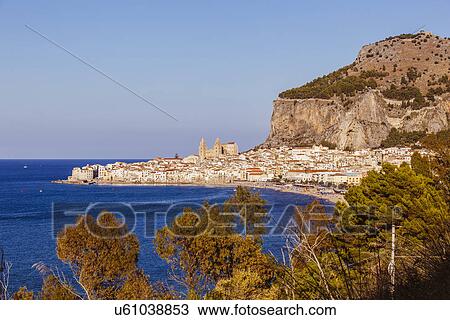Stock Image - View of coastline and Cefalu in Sicily, Italy. Fotosearch
