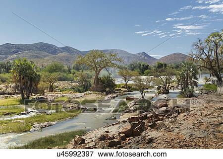 Stock Photo - View of Epupa Falls and distant mountains, Namibia. Fotosearch