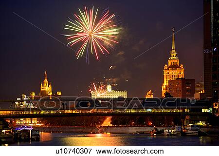 Stock Photo - View of fireworks above White House and Bagration bridge at night, Moscow, Russia. Fotosearch