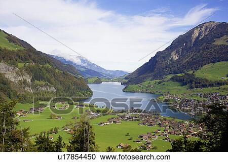 View of mountains and lakeside village, Switzerland View Large Photo Image Stock Image - View of mountains and lakeside village, Switzerland. Fotosearch