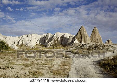 Stock Photo - View of pinnacle rock formations and dirt track, Cappadocia, Anatolia, Turkey. Fotosearch