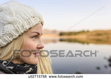 Stock Photo - Woman by lake, Reykjavik, Iceland. Fotosearch