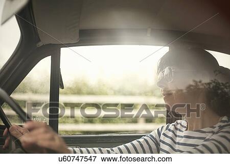 Woman driving a car View Large Photo Image Stock Photo - Woman driving a car. Fotosearch