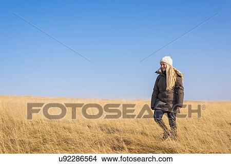 Picture - Woman on field, Reykjavik, Iceland. Fotosearch