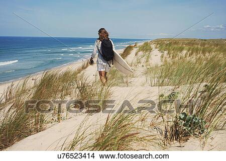 Woman with surfboard on beach, Lacanau, France View Large Photo Image Picture - Woman with surfboard on beach, Lacanau, France. Fotosearch