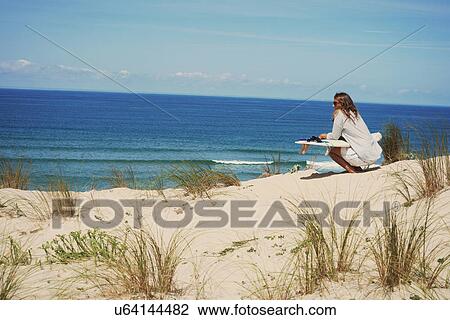 Woman with surfboard on beach, Lacanau, France View Large Photo Image Stock Image - Woman with surfboard on beach, Lacanau, France. Fotosearch