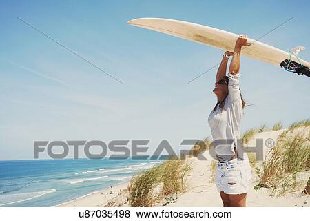 Woman with surfboard on beach, Lacanau, France View Large Photo Image Stock Photo - Woman with surfboard on beach, Lacanau, France. Fotosearch