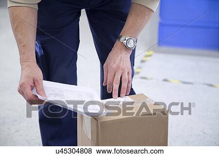 Worker checking packaging at healthcare warehouse View Large Photo Image Stock Photo - Worker checking packaging at healthcare warehouse. Fotosearch