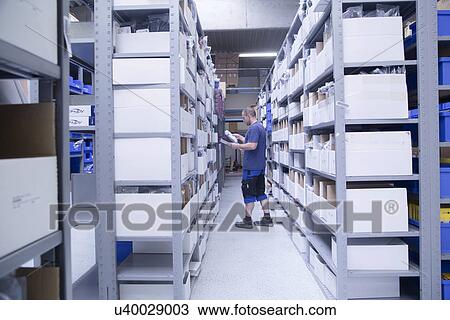 Worker checking stocks at healthcare warehouse View Large Photo Image Stock Image - Worker checking stocks at healthcare warehouse. Fotosearch