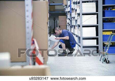 Worker checking stocks at healthcare warehouse View Large Photo Image Stock Photo - Worker checking stocks at healthcare warehouse. Fotosearch