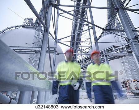 Workers walking towards camera at biomass facility View Large Photo Image Stock Image - Workers walking towards camera at biomass facility. Fotosearch