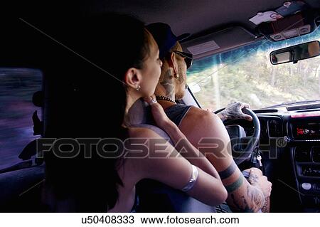 Stock Image - Young couple driving on car road trip. Fotosearch