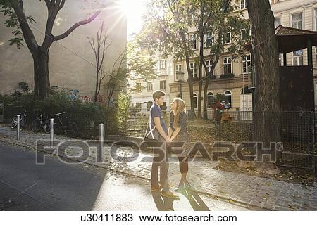 Young couple face to face on suburban street View Large Photo Image Stock Image - Young couple face to face on suburban street. Fotosearch