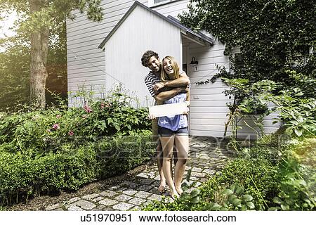 Young couple hugging in garden View Large Photo Image Stock Image - Young couple hugging in garden. Fotosearch