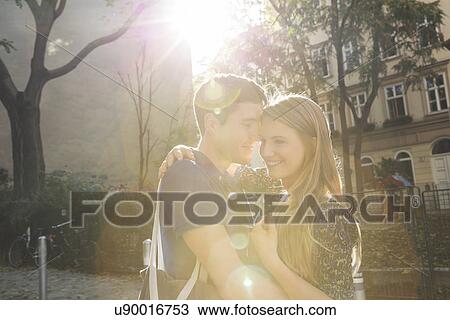 Young couple hugging on suburban street View Large Photo Image Stock Image - Young couple hugging on suburban street. Fotosearch