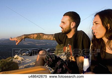 Stock Photography - Young couple pointing and looking out to sea, Marseille, France. Fotosearch