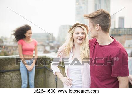 Young couple with arms around each other View Large Photo Image Stock Image - Young couple with arms around each other. Fotosearch