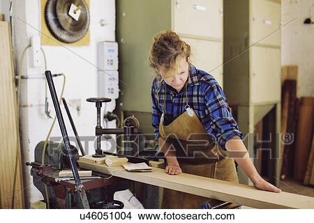 Young craftswoman checking wood in pipe organ workshop View Large Photo Image Picture - Young craftswoman checking wood in pipe organ workshop. Fotosearch