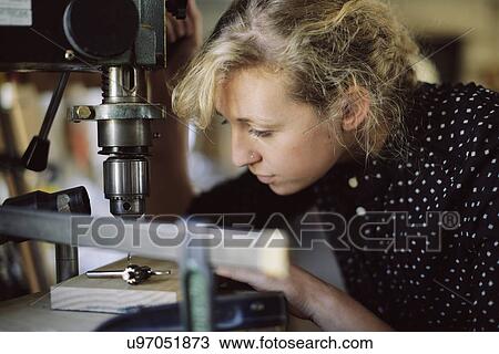 Young craftswoman drilling component in pipe organ workshop View Large Photo Image Stock Image - Young craftswoman drilling component in pipe organ workshop. Fotosearch