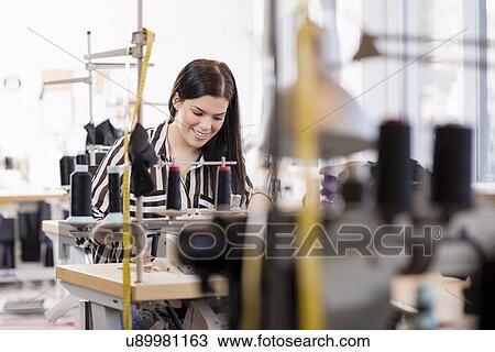 Young female seamstress using sewing machine in workshop View Large Photo Image Stock Image - Young female seamstress using sewing machine in workshop. Fotosearch