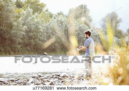 Young man fishing in river, Premosello, Verbania, Piemonte, Italy View Large Photo Image Stock Image - Young man fishing in river, Premosello, Verbania, Piemonte, Italy. Fotosearch