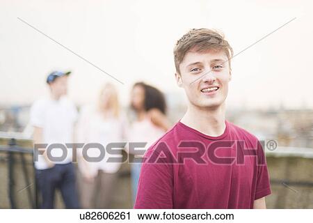 Stock Image - Young man wearing red t shirt. Fotosearch