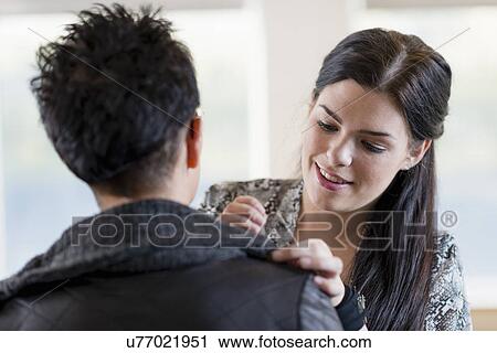 Young seamstress adjusting shoulder of customers jacket in workshop View Large Photo Image Stock Image - Young seamstress adjusting shoulder of customers jacket in workshop. Fotosearch