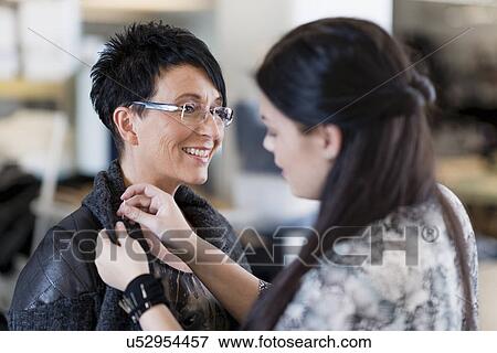 Young seamstress pinning shoulder of customers jacket in workshop View Large Photo Image Stock Photo - Young seamstress pinning shoulder of customers jacket in workshop. Fotosearch