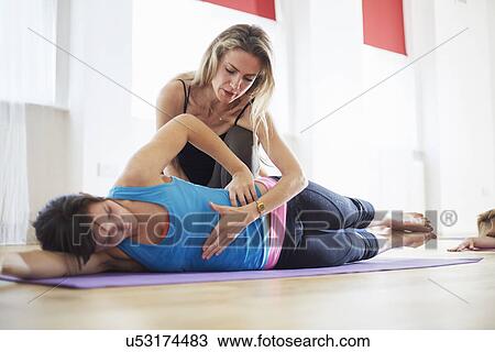 Young woman and tutor in pilates class View Large Photo Image Stock Image - Young woman and tutor in pilates class. Fotosearch