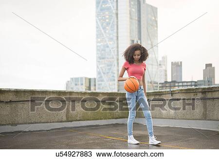 Young woman bouncing basketball View Large Photo Image Stock Image - Young woman bouncing basketball. Fotosearch