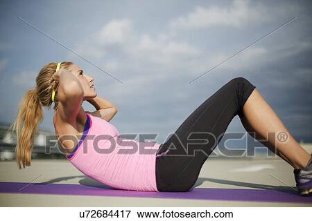 Young woman doing sit ups View Large Photo Image Stock Photo - Young woman doing sit ups. Fotosearch