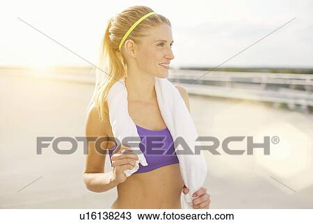 Young woman holding towel View Large Photo Image Stock Image - Young woman holding towel. Fotosearch