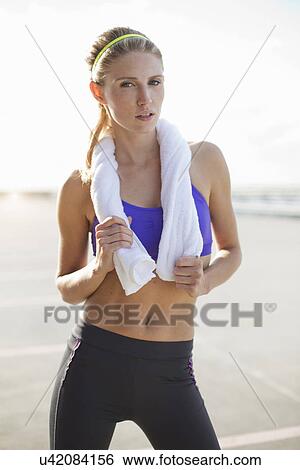 Young woman holding towel View Large Photo Image Stock Photograph - Young woman holding towel. Fotosearch