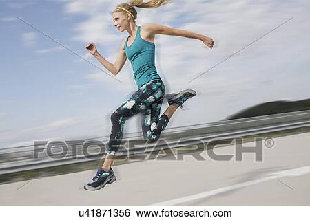 Young woman jumping View Large Photo Image Stock Photograph - Young woman jumping. Fotosearch