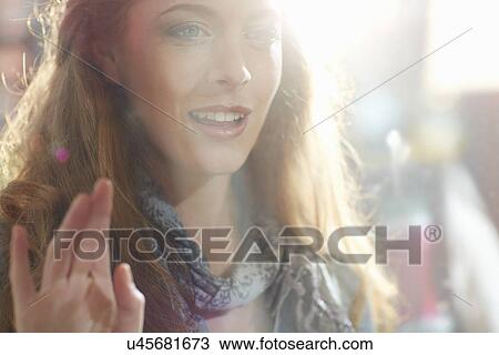 Young woman looking in shop window View Large Photo Image Stock Image - Young woman looking in shop window. Fotosearch