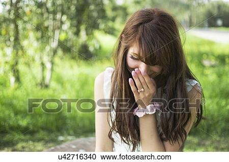 Young woman outdoors, laughing View Large Photo Image Stock Image - Young woman outdoors, laughing. Fotosearch