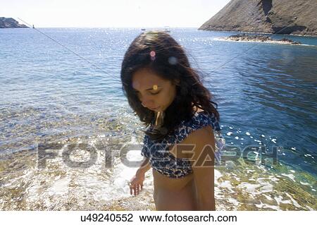 Young woman paddling in sea, Marseille, France View Large Photo Image Stock Image - Young woman paddling in sea, Marseille, France. Fotosearch
