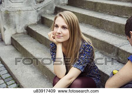 Young woman sitting on old street stairway daydreaming View Large Photo Image Stock Photo - Young woman sitting on old street stairway daydreaming. Fotosearch