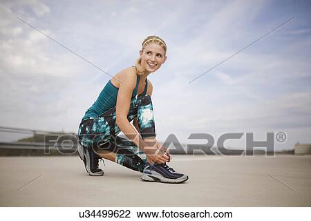 Young woman tying trainers View Large Photo Image Stock Image - Young woman tying trainers. Fotosearch
