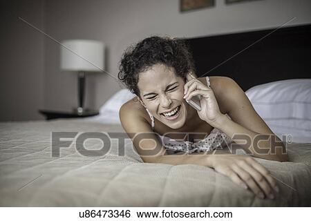 Young woman using cell phone View Large Photo Image Stock Photograph - Young woman using cell phone. Fotosearch