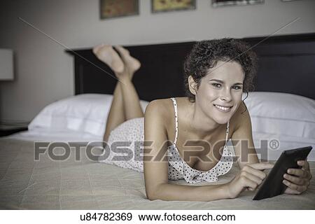 Stock Photo - Young woman using digital tablet. Fotosearch